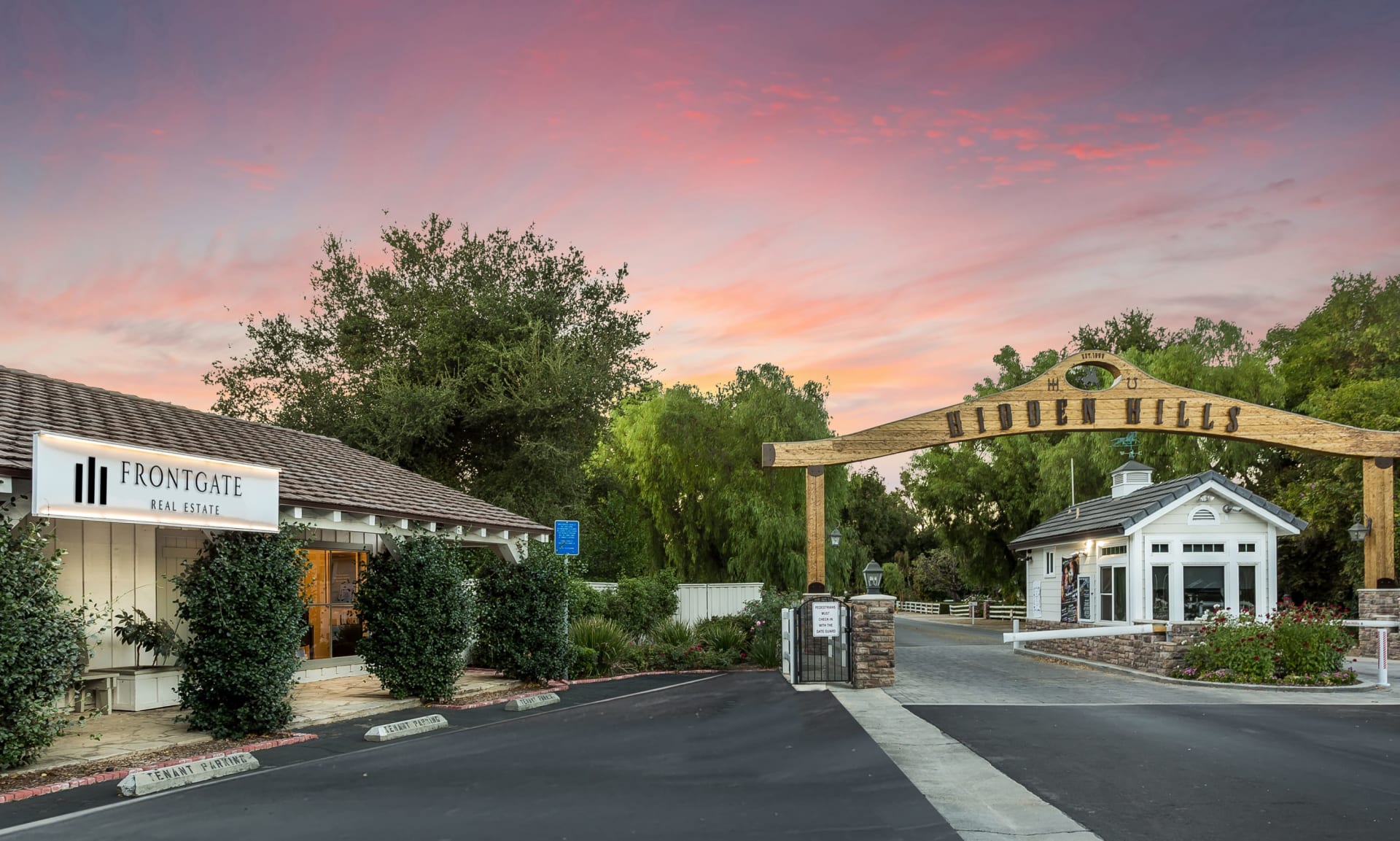 Luxury gated community entrance at sunset
